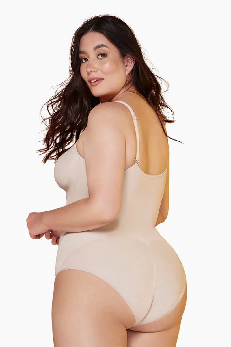 Back view of nude Curveez Comfort Evolution Bodysuit on plus-size model, designed for smooth shaping and enhanced curves.